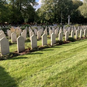 Rows of white headstones set into bright green grass