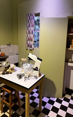 A photograph of a Kenwood Mixer in a vintage kitchen